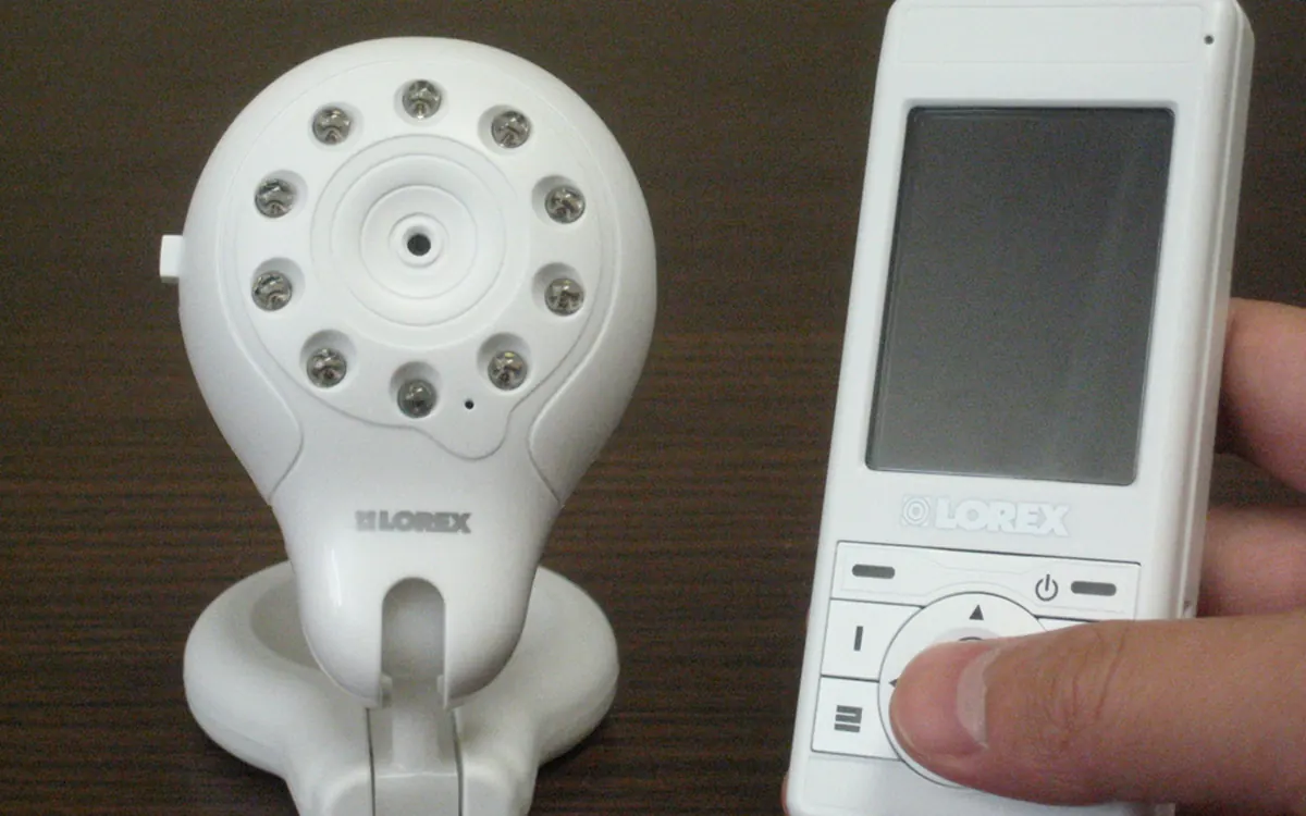 Digital wireless video baby monitor: white camera with infrared LEDs and a handheld parent unit (illustrative photo)