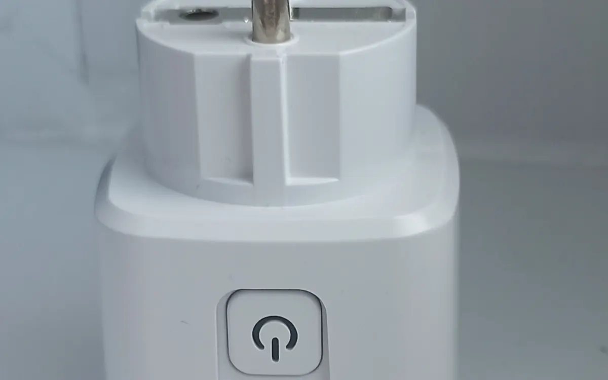 A white smart plug adapter with a power button, the simplest first smart home device (illustrative photo)
