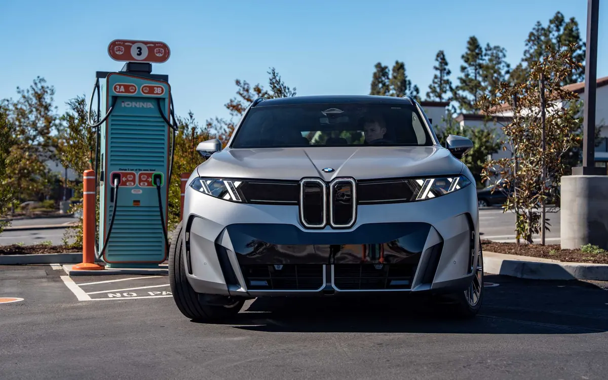 A silver BMW iX5 parked next to an IONNA fast charger at the Southern California charging demonstration