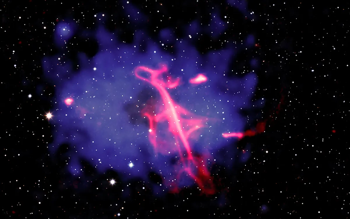 Composite image of the Treble Clef radio source: pink radio emission over a blue cloud of hot X-ray gas in a galaxy cluster