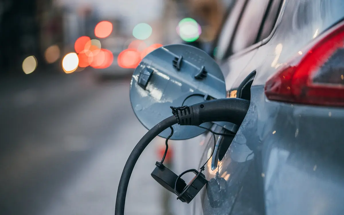 An electric car plugged in to charge