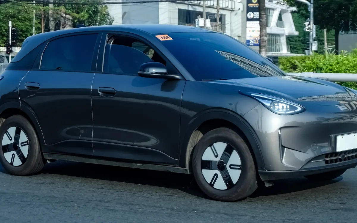 A grey Geely EX2 electric hatchback parked on a sunny street