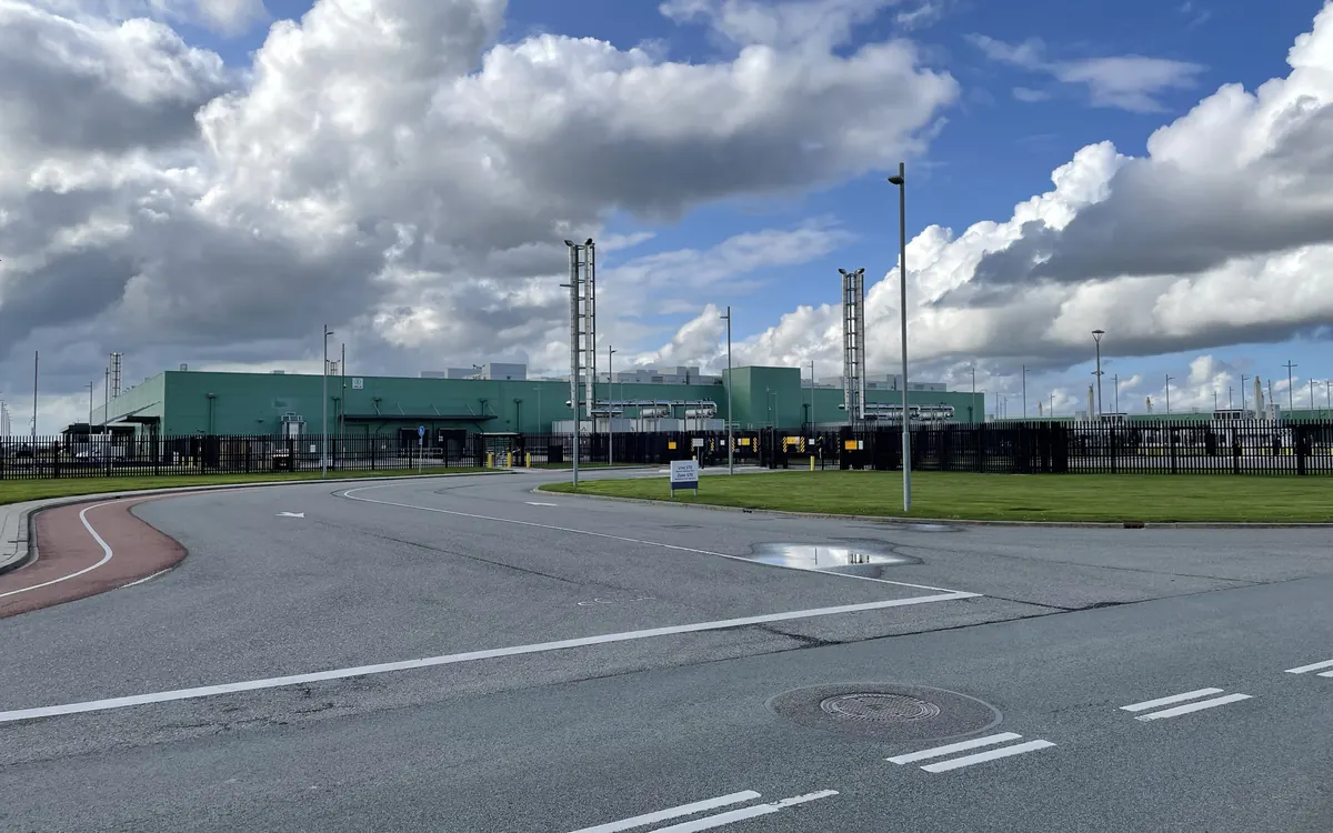 Low green Microsoft data centre buildings behind a fence and an empty road in Middenmeer, the Netherlands (illustrative photo, not the Loughton site)