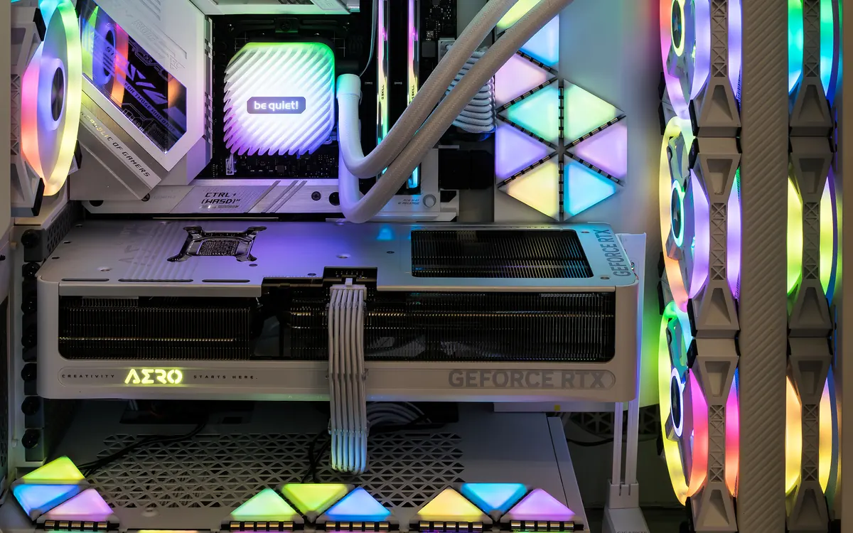 Inside a white desktop gaming PC with an AIO liquid cooler, a GeForce RTX graphics card and RGB case fans