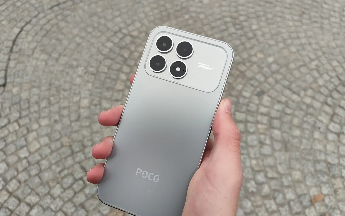 A hand holding a silver POCO F8 Pro phone, showing its square camera module (illustrative photo, not the POCO X8s)