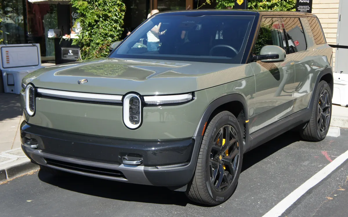 A green Rivian R2 electric SUV parked at the kerb (illustrative photo)