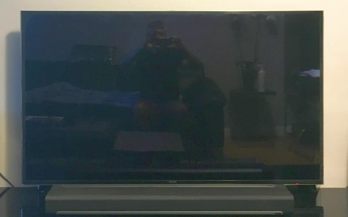 Samsung flat-screen TV with a soundbar below it in a living room (illustrative photo)