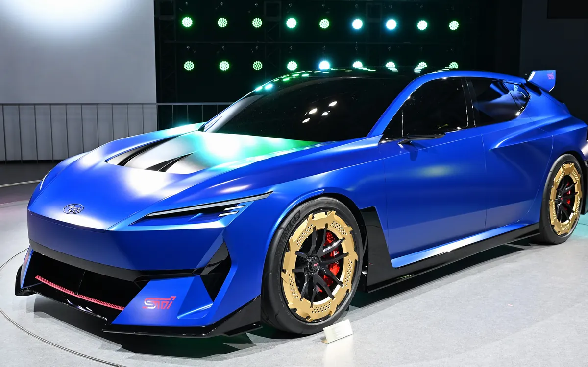 Blue Subaru Performance-E STI concept on a stand at the Japan Mobility Show 2025 (illustrative photo, not the prototype)