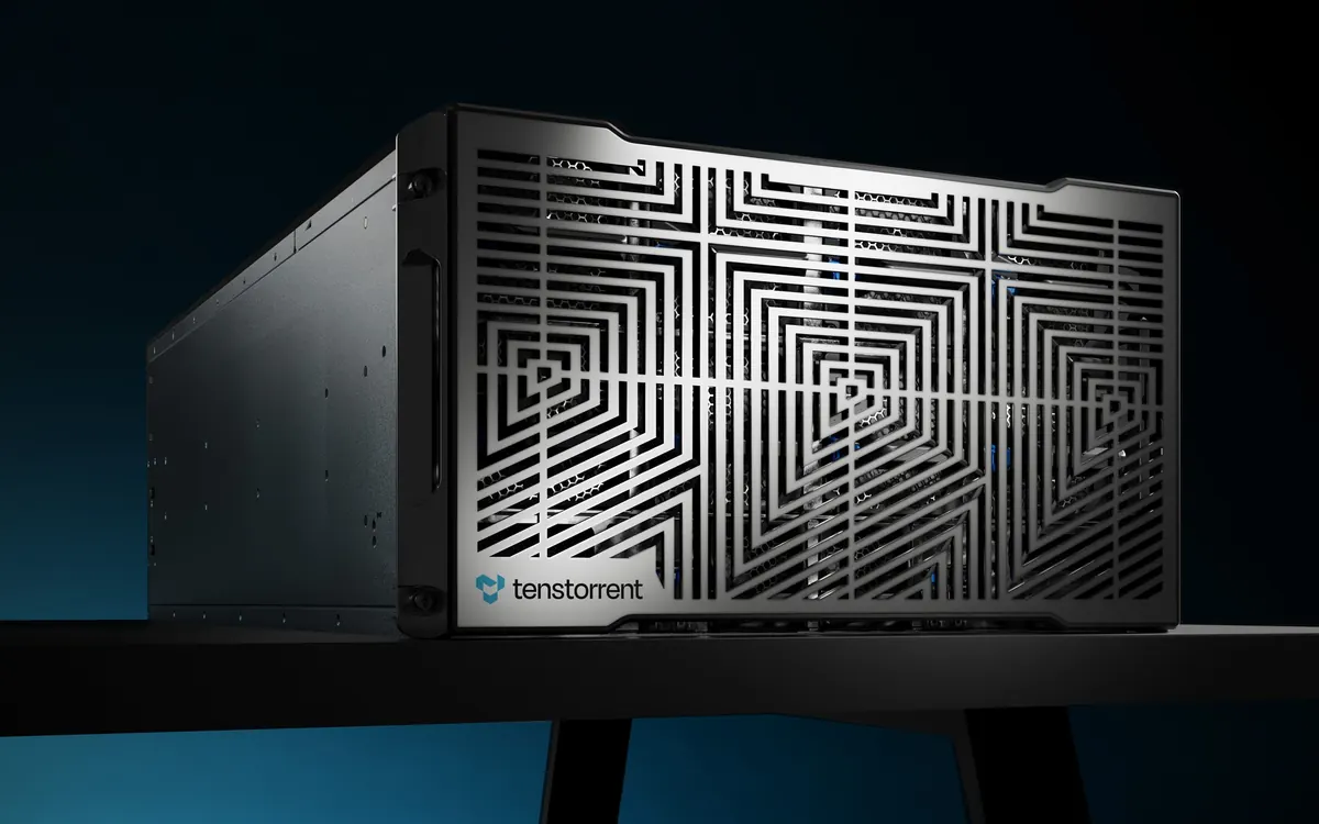 A black Tenstorrent Galaxy AI server with a geometric metal front grille and the Tenstorrent logo, on a dark stand