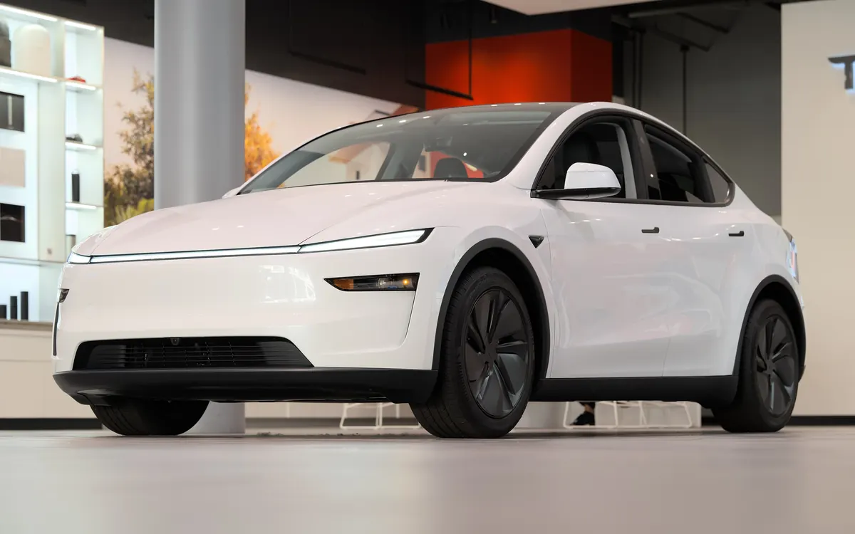 A white 2025 Tesla Model Y on display in a Tesla showroom (illustrative photo)