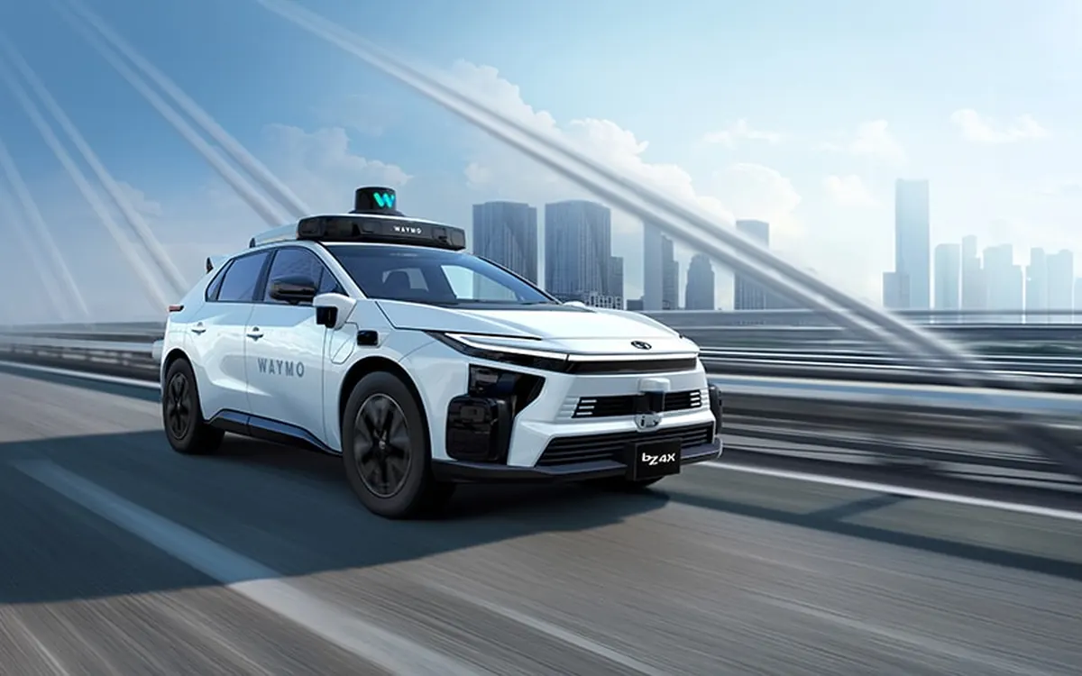 Rendering of a white Toyota bZ4X robotaxi with Waymo sensors on the roof driving on a city highway